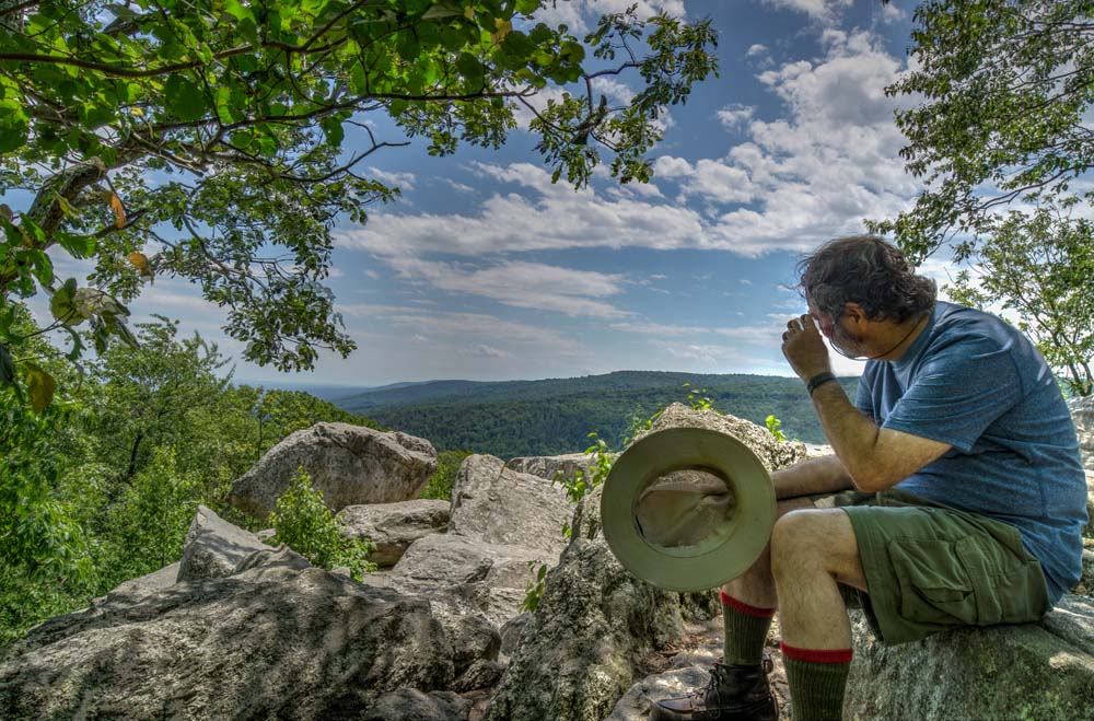 Howard sitting on rock and taking in the view of Chimney Rock