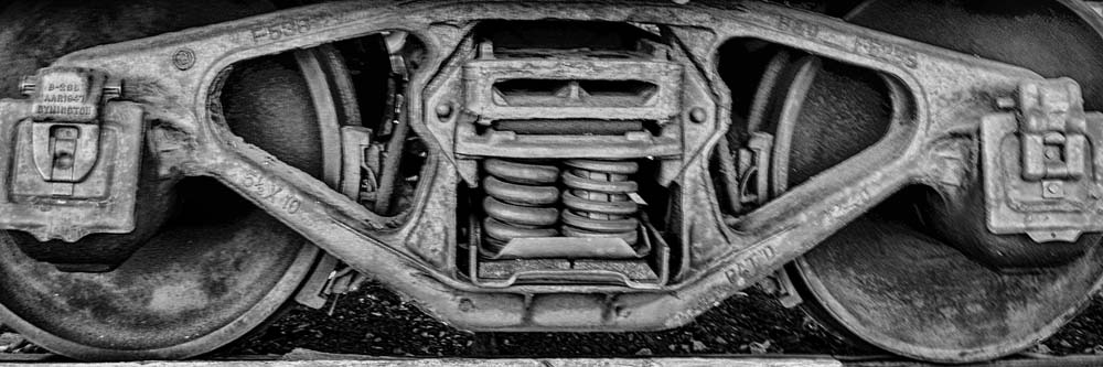 Side view of a railroad truck under a railroad car