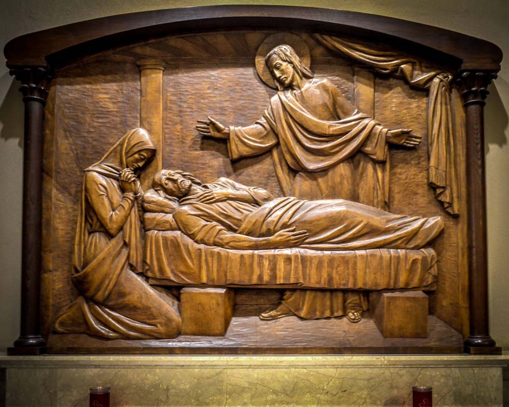 Carved wooden relief of the death of Saint Joselph surrounded by his family