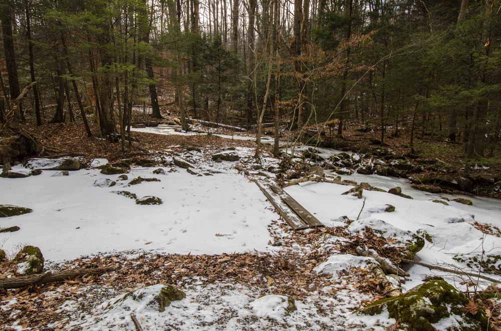 Appalachian Trail in winter crossing Antietam Creek on two boards