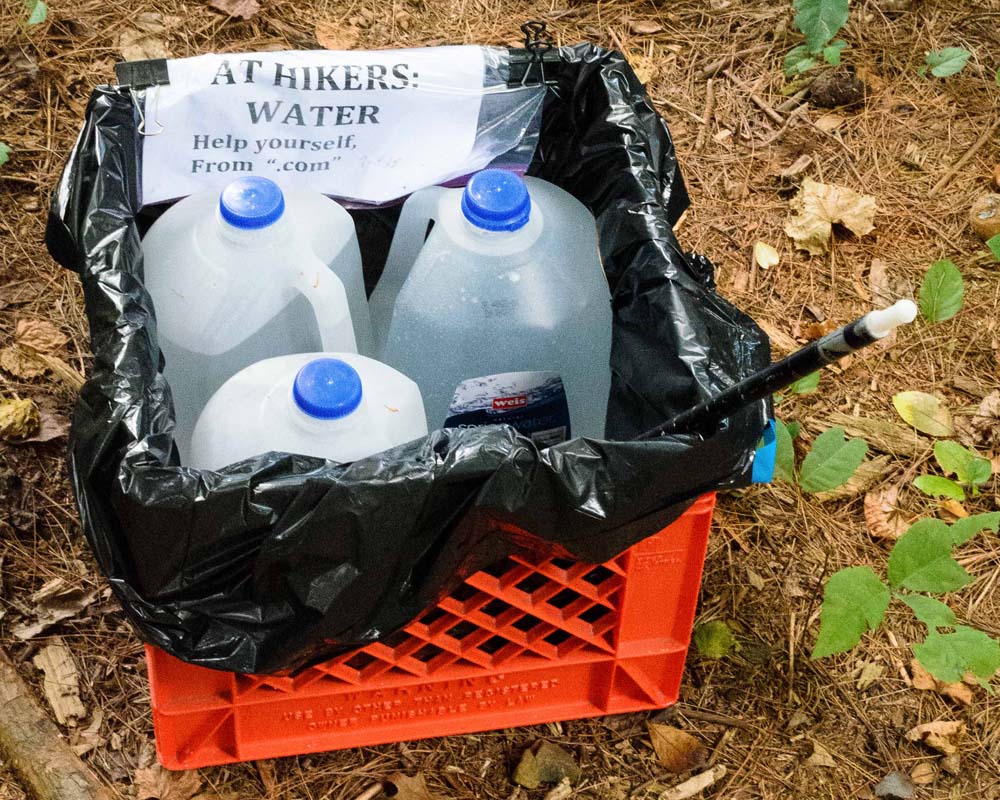 Milk crate with gallon-size bottles of water