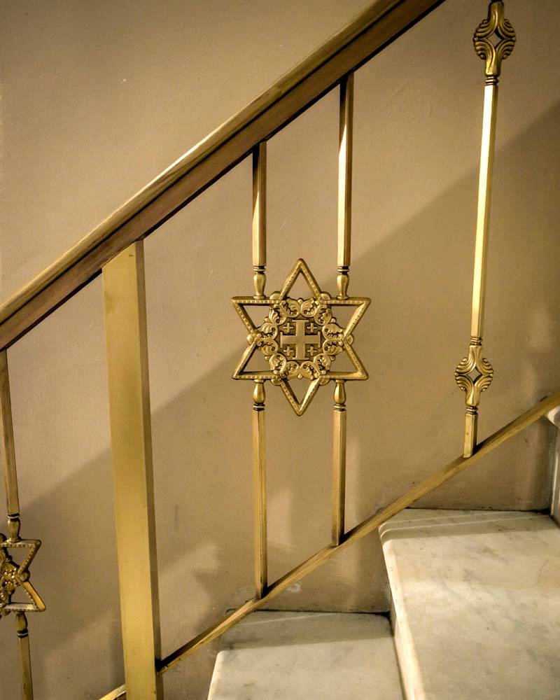 Stairway with handrail, showing Monastery logo