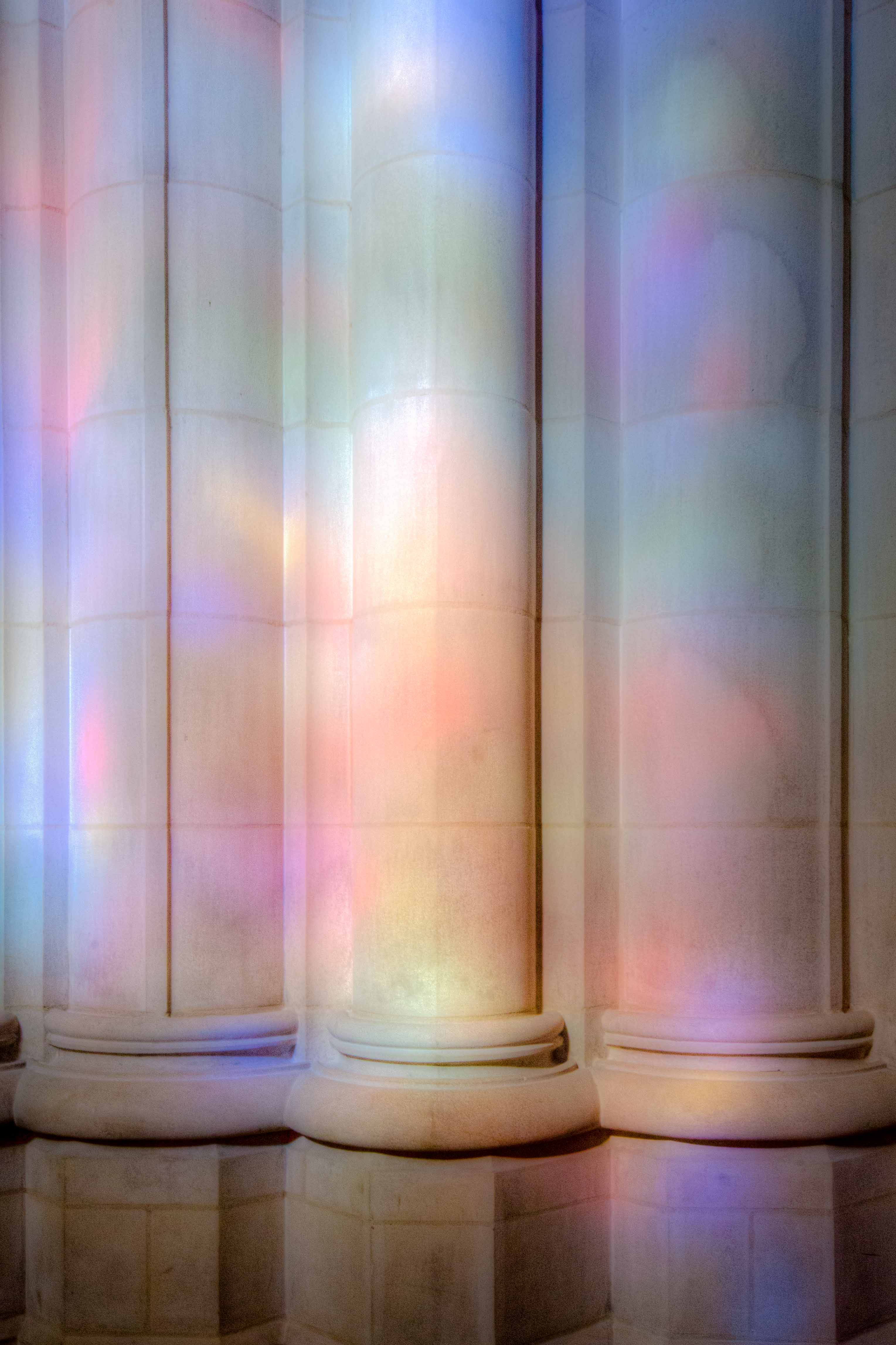 Base of a stone column illuminated by colors
